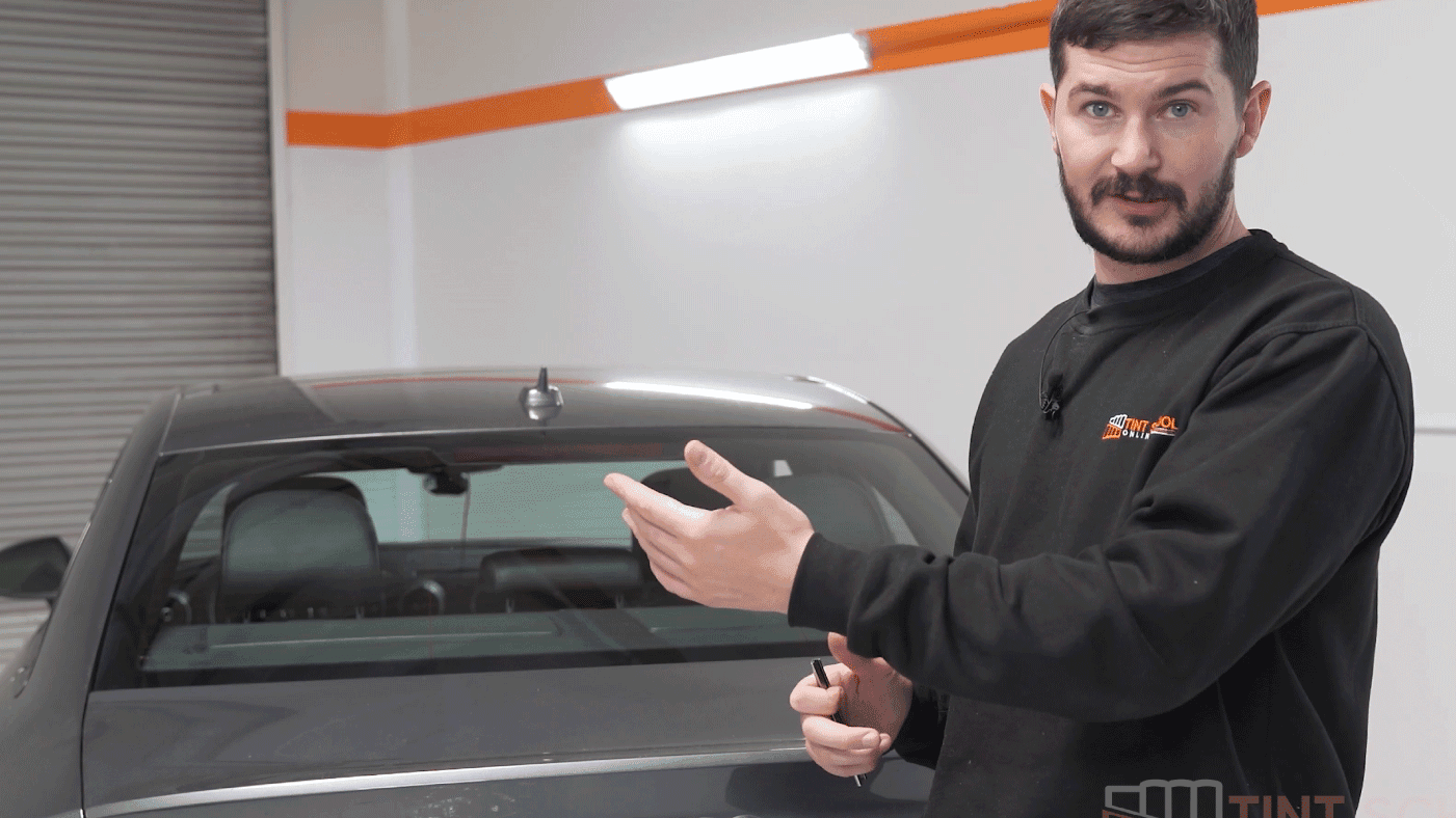 Elliot Baker teaching beside a car at the training workshop